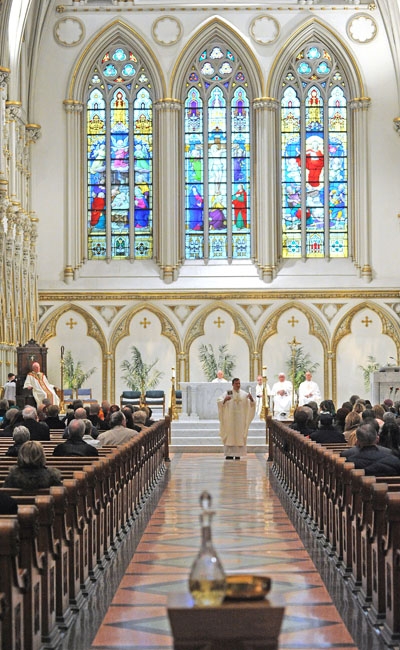 Framed by Bishop Richard J. Malone, Rev. Ryszard S. Biernat speaks about his Polish heritage during a mass celebrating 1,050 years of Polish commitment to the Catholic faith at St Joseph Cathedral in Downtown Buffalo. (Photo by Dan Cappellazzo)